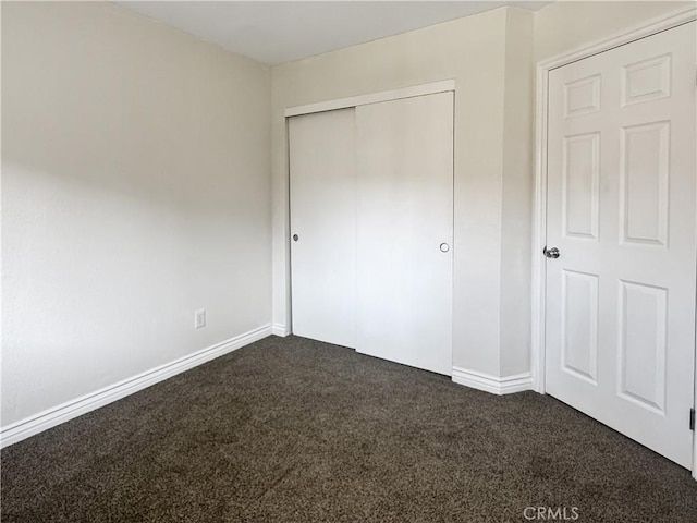 2414 Grove Ave, San Diego, CA 92154 - unfurnished bedroom with dark carpet, a closet, and baseboards