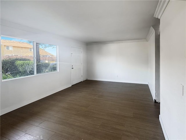 2414 Grove Ave, San Diego, CA 92154 - empty room featuring dark wood-type flooring, crown molding, and baseboards