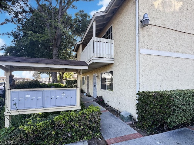 2414 Grove Ave, San Diego, CA 92154 - view of property exterior with mail area, stucco siding, and a balcony