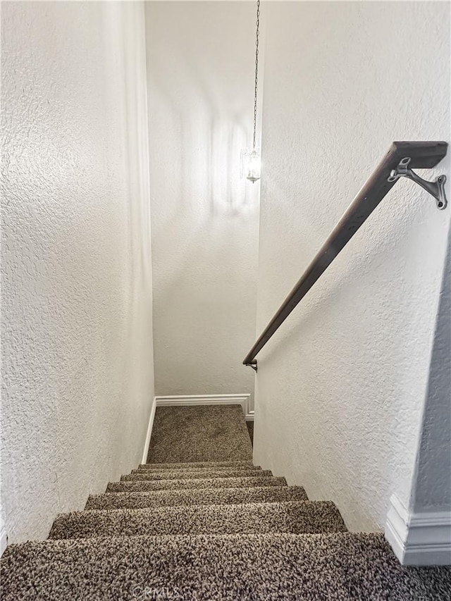 2414 Grove Ave, San Diego, CA 92154 - staircase with carpet, a textured wall, and baseboards