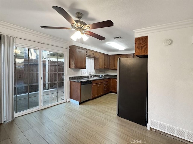 2414 Grove Ave, San Diego, CA 92154 - kitchen with stainless steel appliances, dark countertops, ceiling fan, light wood-style flooring, and ornamental molding