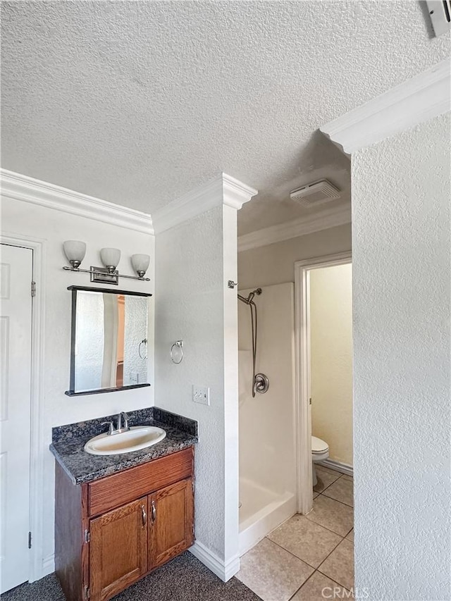 2414 Grove Ave, San Diego, CA 92154 - bathroom featuring ornamental molding, a textured ceiling, a stall shower, toilet, and vanity