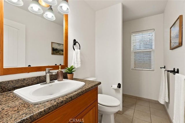 bathroom featuring tile patterned floors, toilet, and vanity