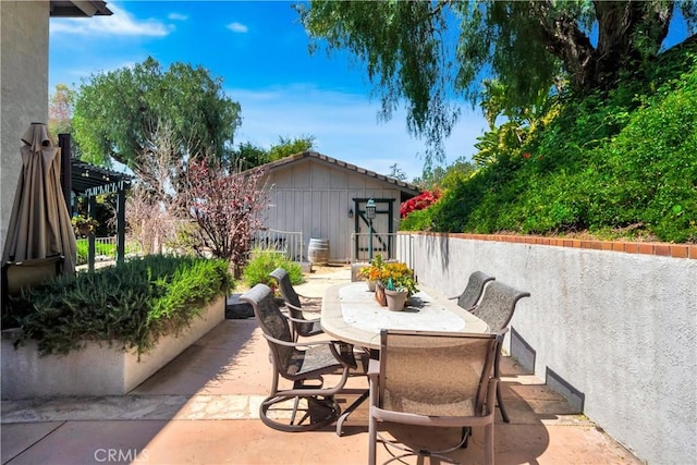 view of patio / terrace with a pergola and outdoor dining space