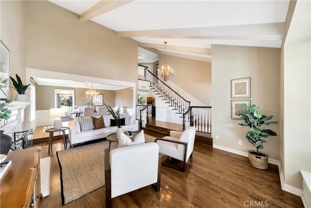 living room featuring wood finished floors, beam ceiling, a chandelier, and stairs