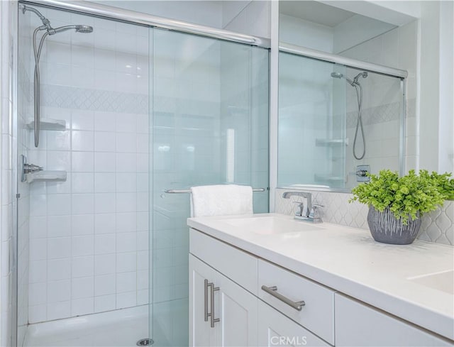 full bath with a shower stall and vanity