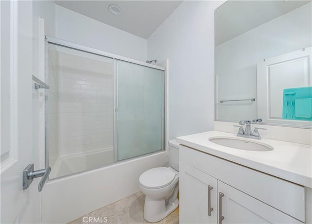 full bathroom with toilet, vanity, and bath / shower combo with glass door