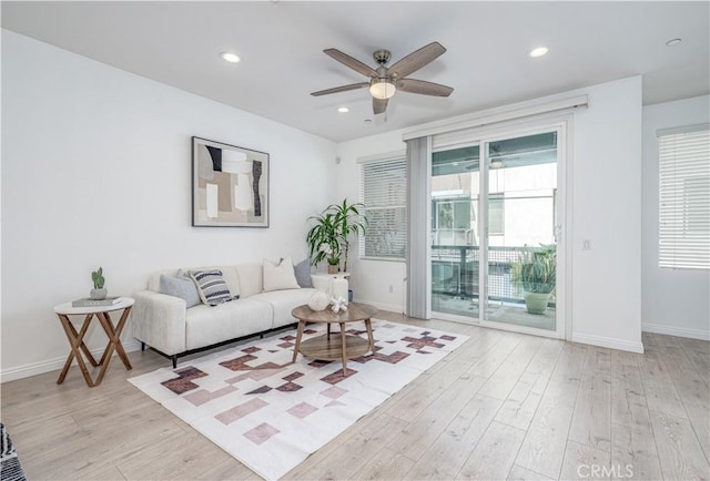 living area featuring ceiling fan, baseboards, light wood-style flooring, and recessed lighting