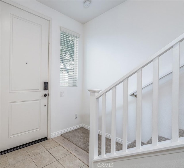 entryway featuring baseboards