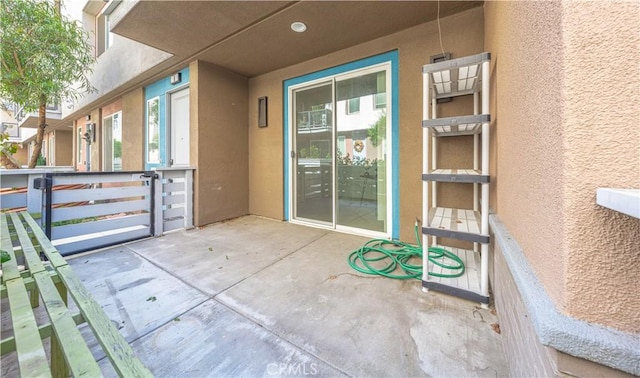 entrance to property featuring stucco siding and a patio