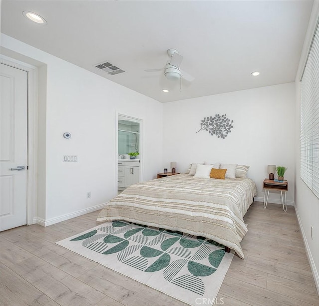 bedroom with light wood-type flooring, baseboards, recessed lighting, a ceiling fan, and ensuite bath