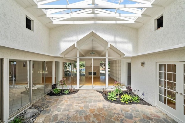 unfurnished sunroom with a skylight