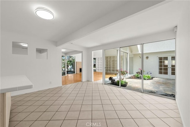 interior space with french doors and beam ceiling