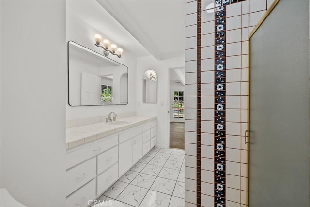 bathroom with marble finish floor and vanity