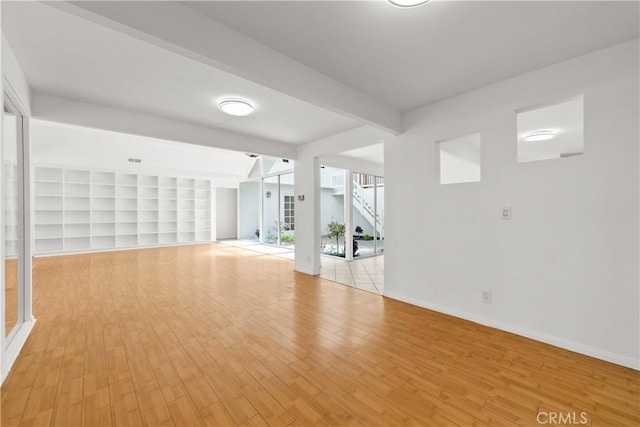 interior space with light wood-style floors and baseboards