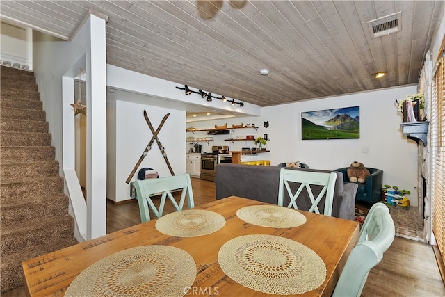 39802 Lakeview Dr Unit 26, Big Bear Lake, CA 92315 - dining space with visible vents, wood ceiling, wood finished floors, and stairs