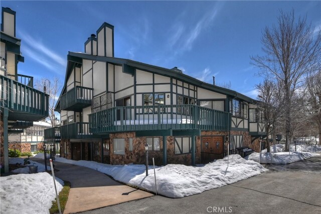 39802 Lakeview Dr Unit 26, Big Bear Lake, CA 92315 - snow covered property with stone siding, stucco siding, and a chimney