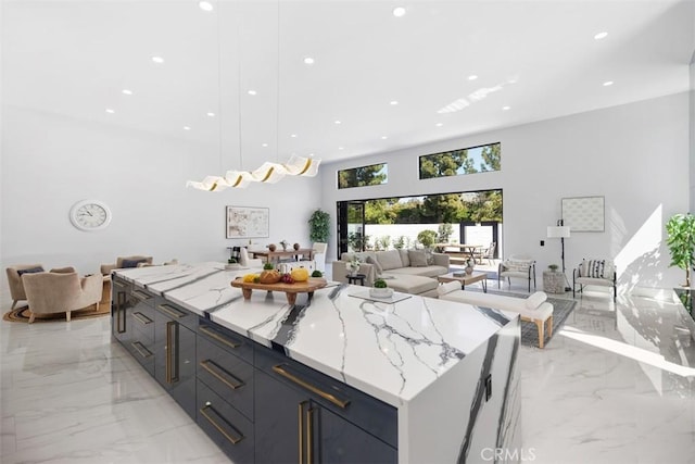 18802 Saginaw Dr, Irvine, CA 92603 - kitchen with light marble finish floors, open floor plan, modern cabinets, light stone counters, and recessed lighting