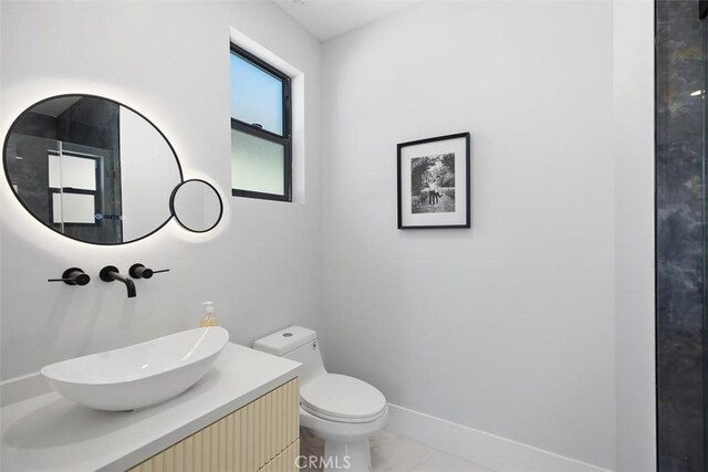 18802 Saginaw Dr, Irvine, CA 92603 - half bathroom featuring vanity, toilet, marble look tiles, and baseboards