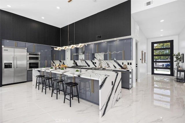 18802 Saginaw Dr, Irvine, CA 92603 - kitchen featuring stainless steel appliances, light marble finish flooring, modern cabinets, a high ceiling, and recessed lighting