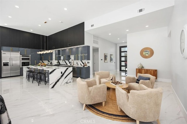 18802 Saginaw Dr, Irvine, CA 92603 - living room featuring light marble finish floors, recessed lighting, and baseboards