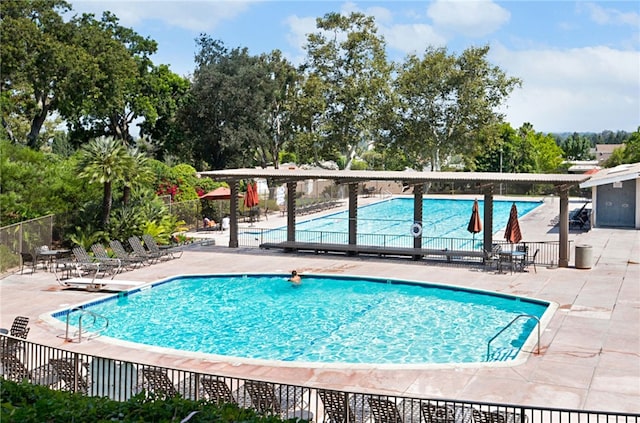 18802 Saginaw Dr, Irvine, CA 92603 - community pool with a patio and view of wooded area