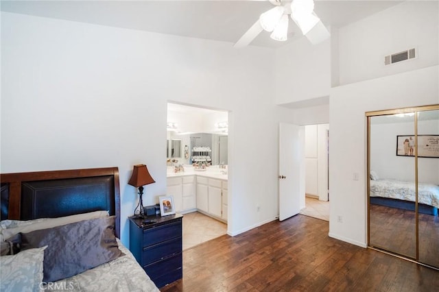 44475 Galicia Dr, Hemet, CA 92544 - bedroom with a towering ceiling, wood finished floors, visible vents, a ceiling fan, and a closet