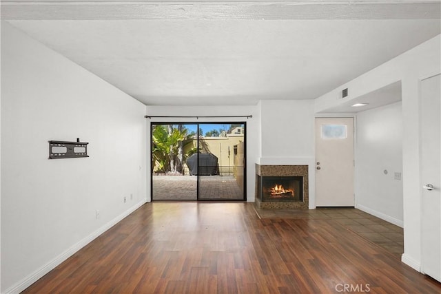 25712 Le Parc Unit 21, Lake Forest, CA 92630 - unfurnished living room featuring wood finished floors and a fireplace with flush hearth