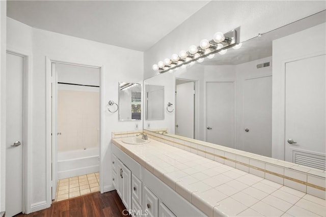 25712 Le Parc Unit 21, Lake Forest, CA 92630 - full bath with vanity, wood finished floors, and washtub / shower combination