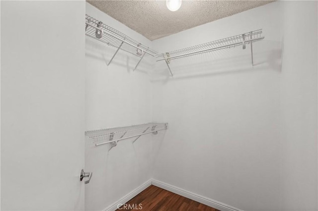 25712 Le Parc Unit 21, Lake Forest, CA 92630 - walk in closet featuring dark wood finished floors