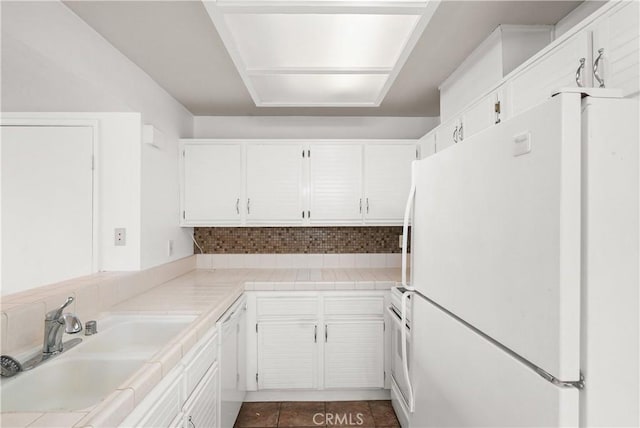 25712 Le Parc Unit 21, Lake Forest, CA 92630 - kitchen featuring white appliances, a sink, white cabinetry, tasteful backsplash, and dark tile patterned flooring