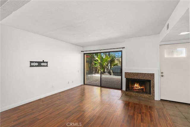 25712 Le Parc Unit 21, Lake Forest, CA 92630 - unfurnished living room with wood finished floors and a tile fireplace
