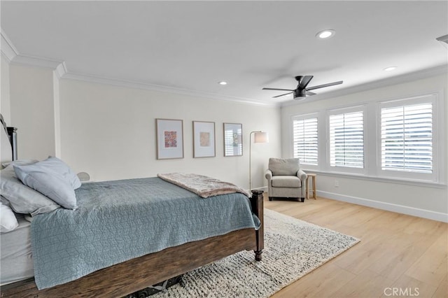 bedroom featuring crown molding, baseboards, wood finished floors, recessed lighting, and a ceiling fan