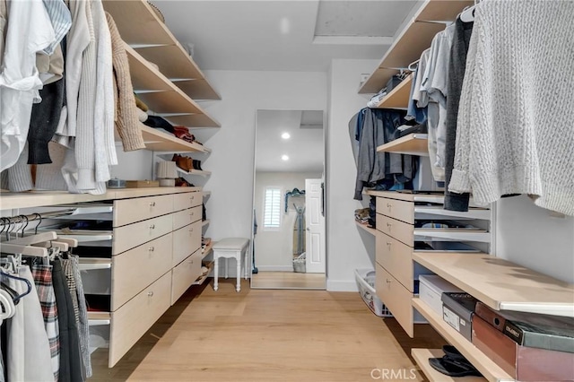 spacious closet featuring attic access and light wood-style flooring