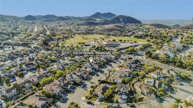 drone / aerial view featuring a residential view and a mountain view