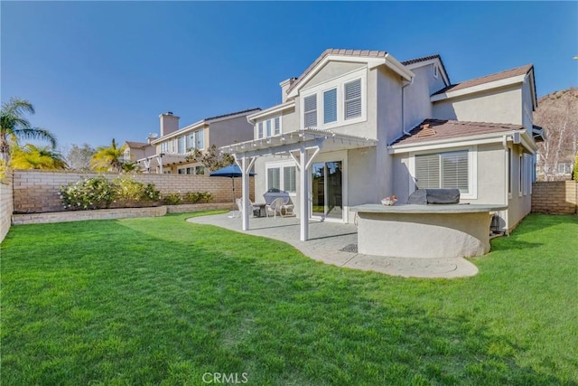 back of property with a pergola, a lawn, stucco siding, and a fenced backyard