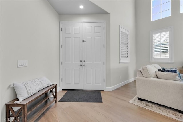entrance foyer with baseboards, light wood-style floors, and recessed lighting