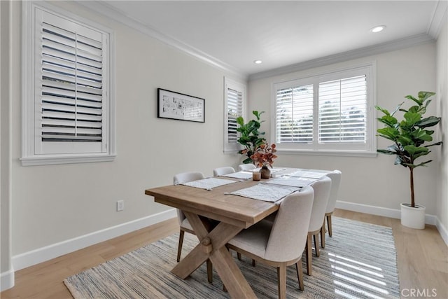dining room with baseboards, ornamental molding, recessed lighting, and light wood-type flooring