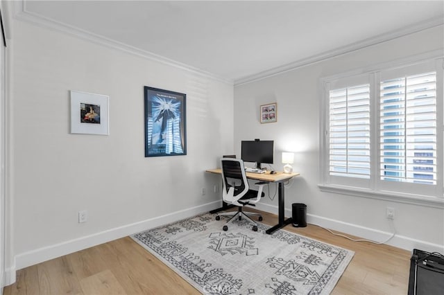 office space featuring baseboards, wood finished floors, and crown molding