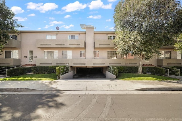 18347 Saticoy St Unit 37, Reseda, CA 91335 - view of building exterior with an attached garage and concrete driveway