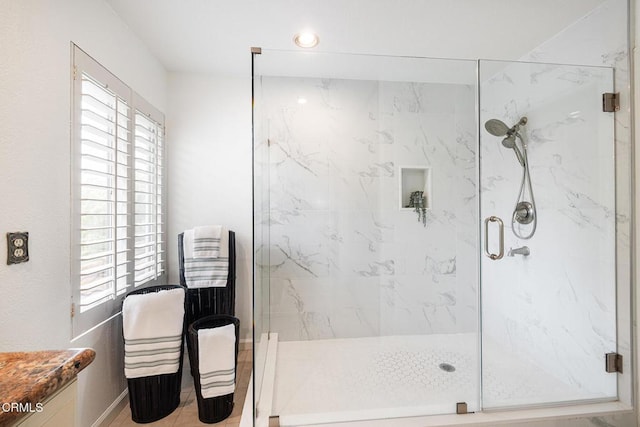 12084 London Grove Ct, Moorpark, CA 93021 - bathroom featuring plenty of natural light, a marble finish shower, and baseboards