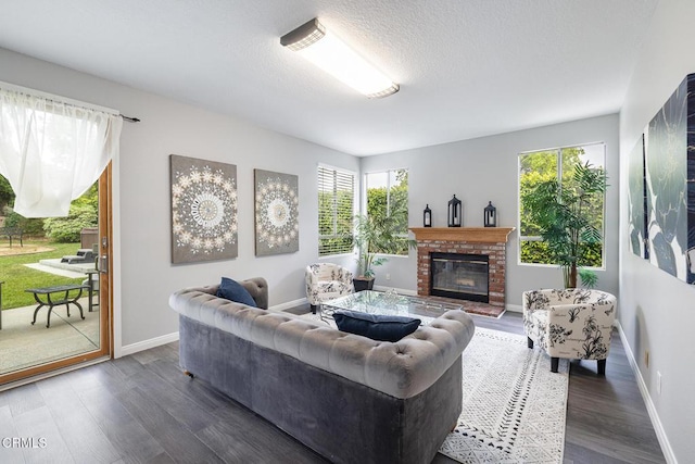 12084 London Grove Ct, Moorpark, CA 93021 - living area featuring a fireplace, dark wood-style floors, baseboards, and a textured ceiling