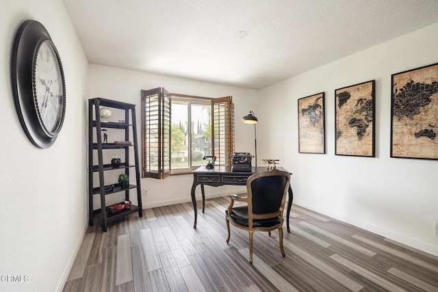 12084 London Grove Ct, Moorpark, CA 93021 - home office with wood finished floors, baseboards, and a textured ceiling