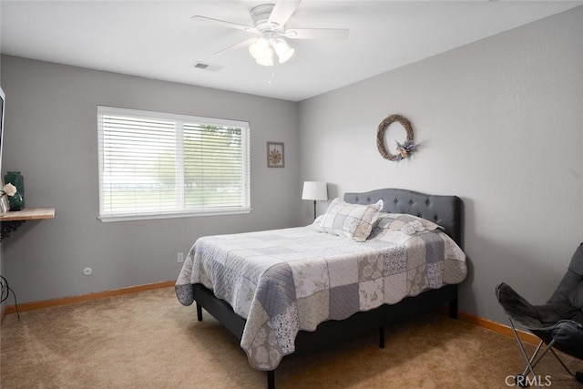 bedroom with baseboards, visible vents, carpet, and a ceiling fan