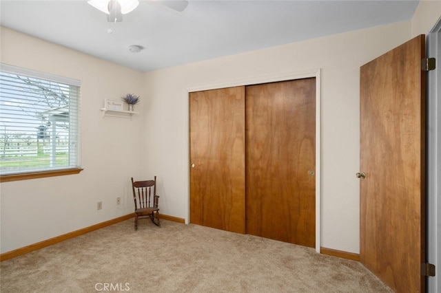 bedroom featuring baseboards, a closet, carpet, and a ceiling fan