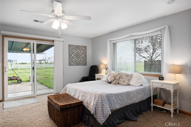 carpeted bedroom with access to outside, baseboards, ceiling fan, and visible vents