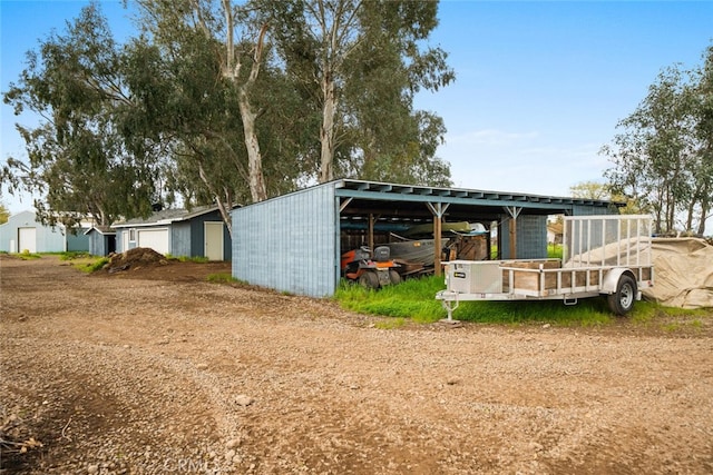 view of pole building with driveway and a carport