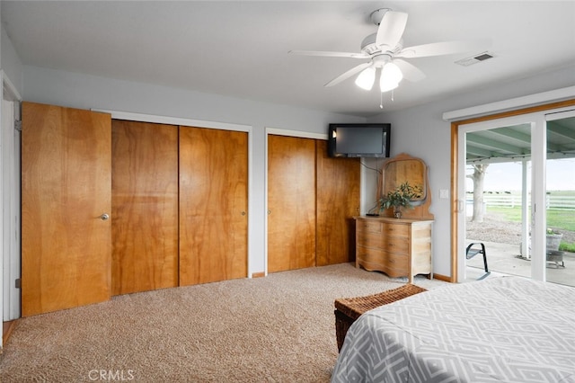 carpeted bedroom featuring a ceiling fan, access to exterior, multiple closets, and visible vents