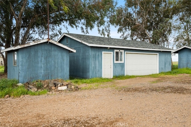 garage with dirt driveway