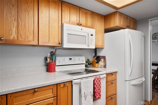 kitchen featuring white appliances and light countertops